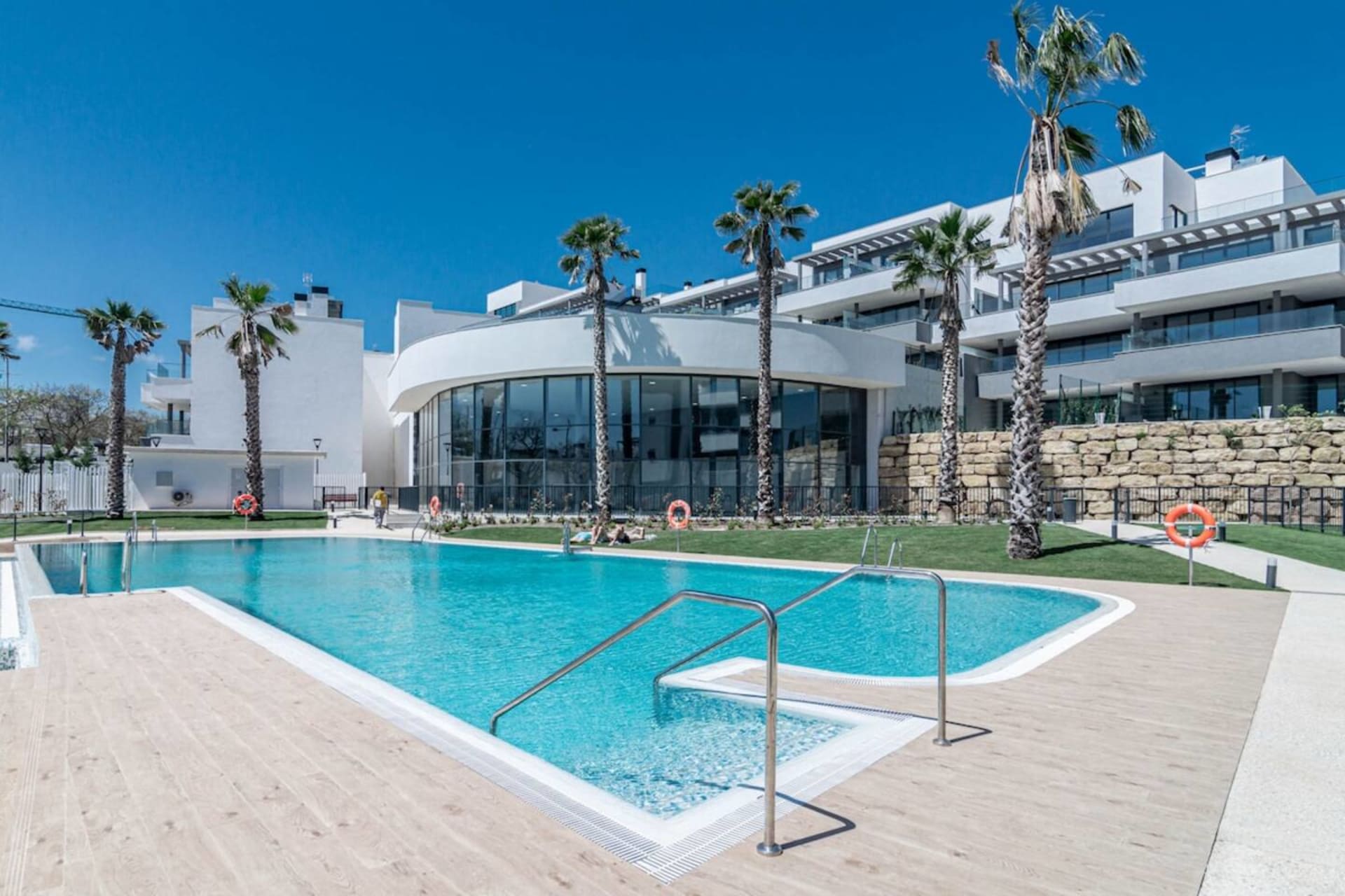 Communal outdoor pool and palm-lined gardens — Spacious Luxury Family Home, Estepona