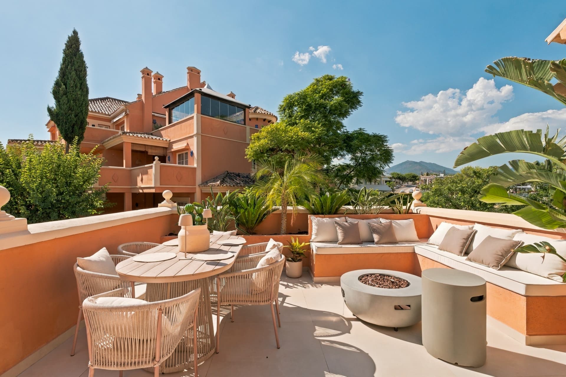 Private rooftop terrace with outdoor dining and a lounge fire pit — Luxury Duplex Penthouse in Nueva Andalucía, Nueva Andalucía