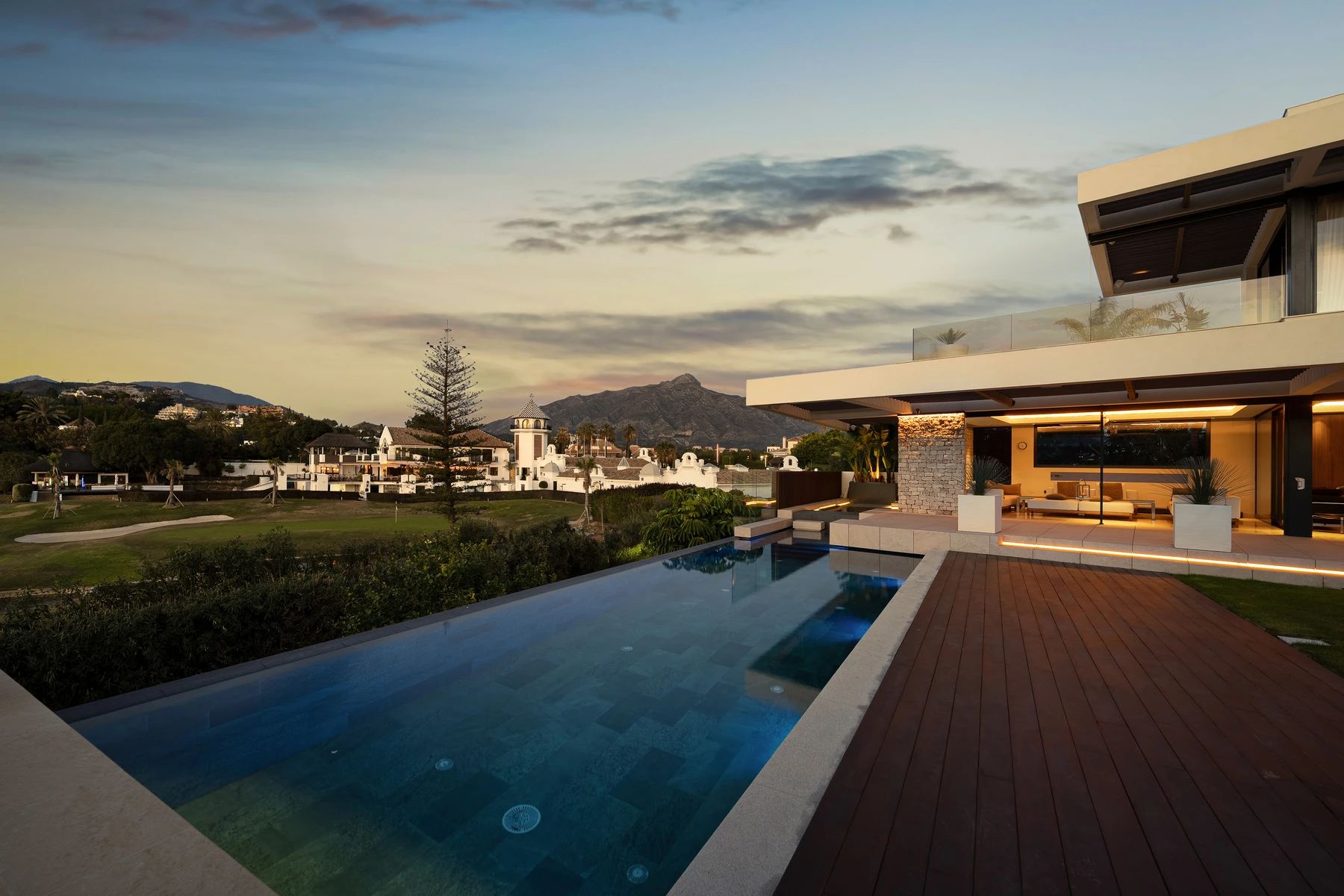 Infinity pool and terrace at sunset overlooking Los Naranjos Golf — Villa Tucan, Nueva Andalucía