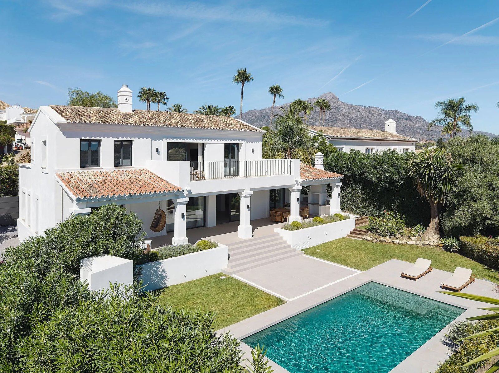 Villa facade with pool and gardens in daylight — Villa Rosalia, Nueva Andalucía