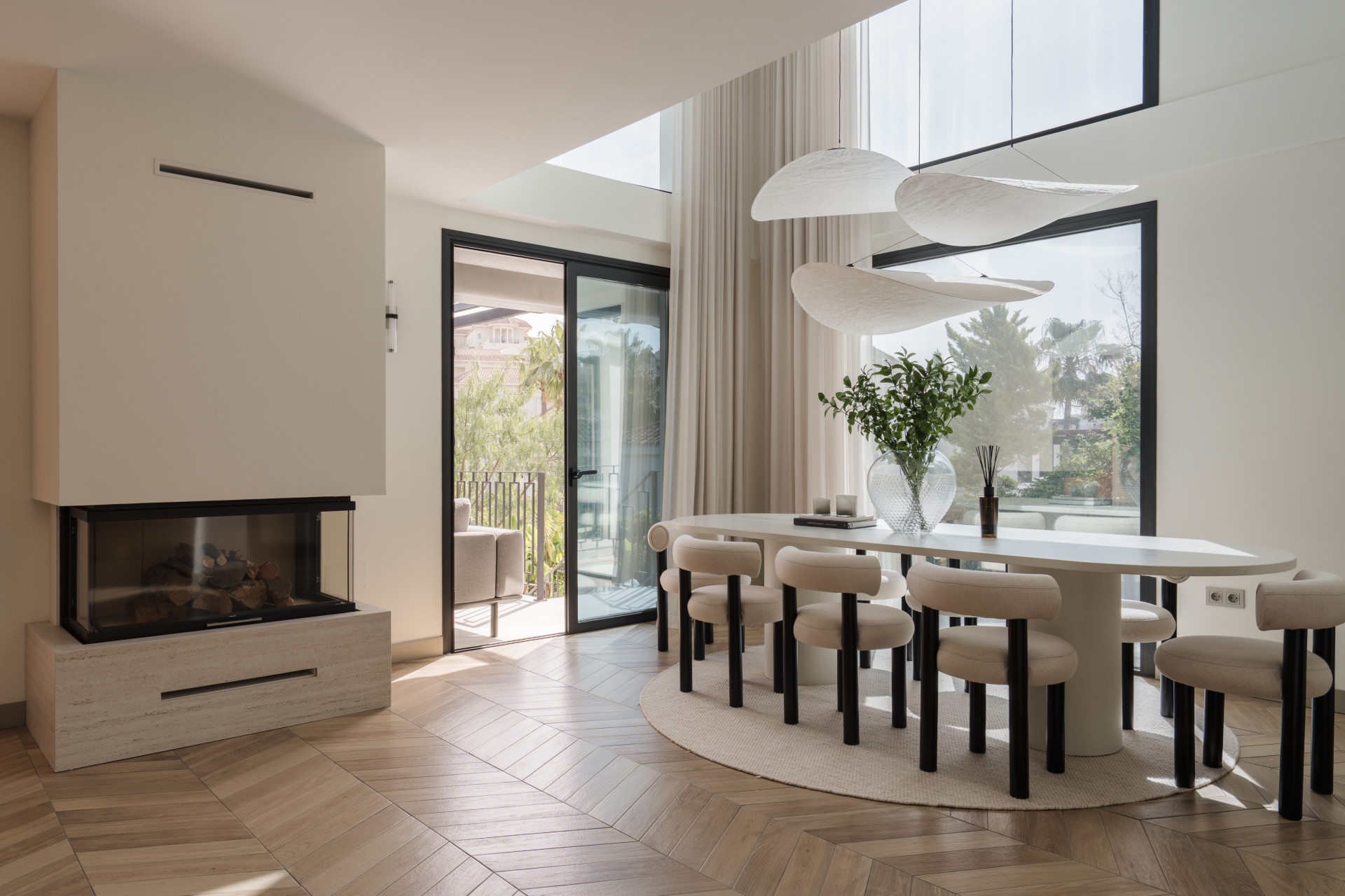 Double-height dining room with fireplace and terrace access — Renovated Villa, Nueva Andalucía